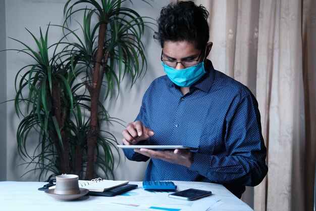 A Venezuelan entrepreneur using accounting software on a tablet, surrounded by organized financial documents and receipts, showcasing a modern and efficient approach to managing finances.