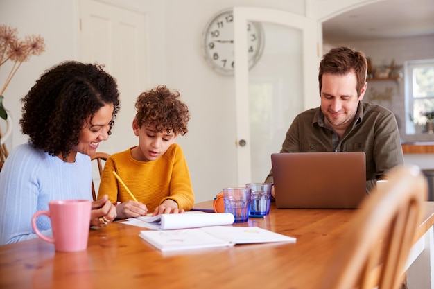 A family sitting together at a table, reviewing financial documents and smiling. The scene conveys a sense of cooperation and financial planning for education.
