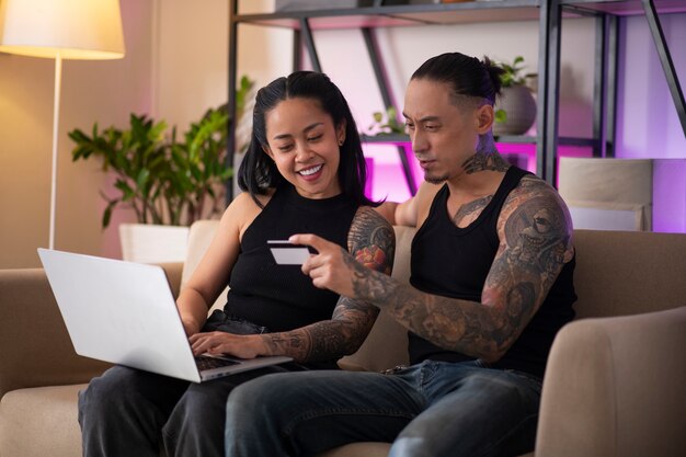A Venezuelan couple sitting on their couch, using a smartphone to track their spending and identify small 
